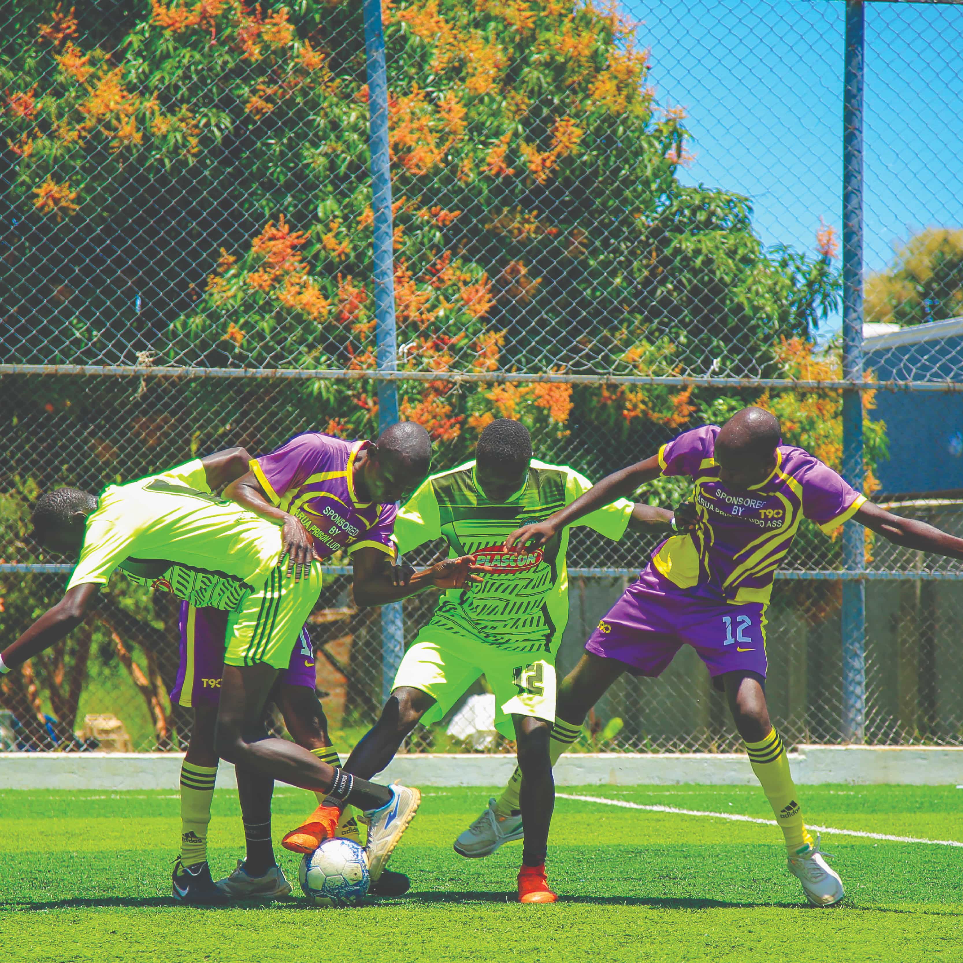 Image of players playing soccer on artificial turf